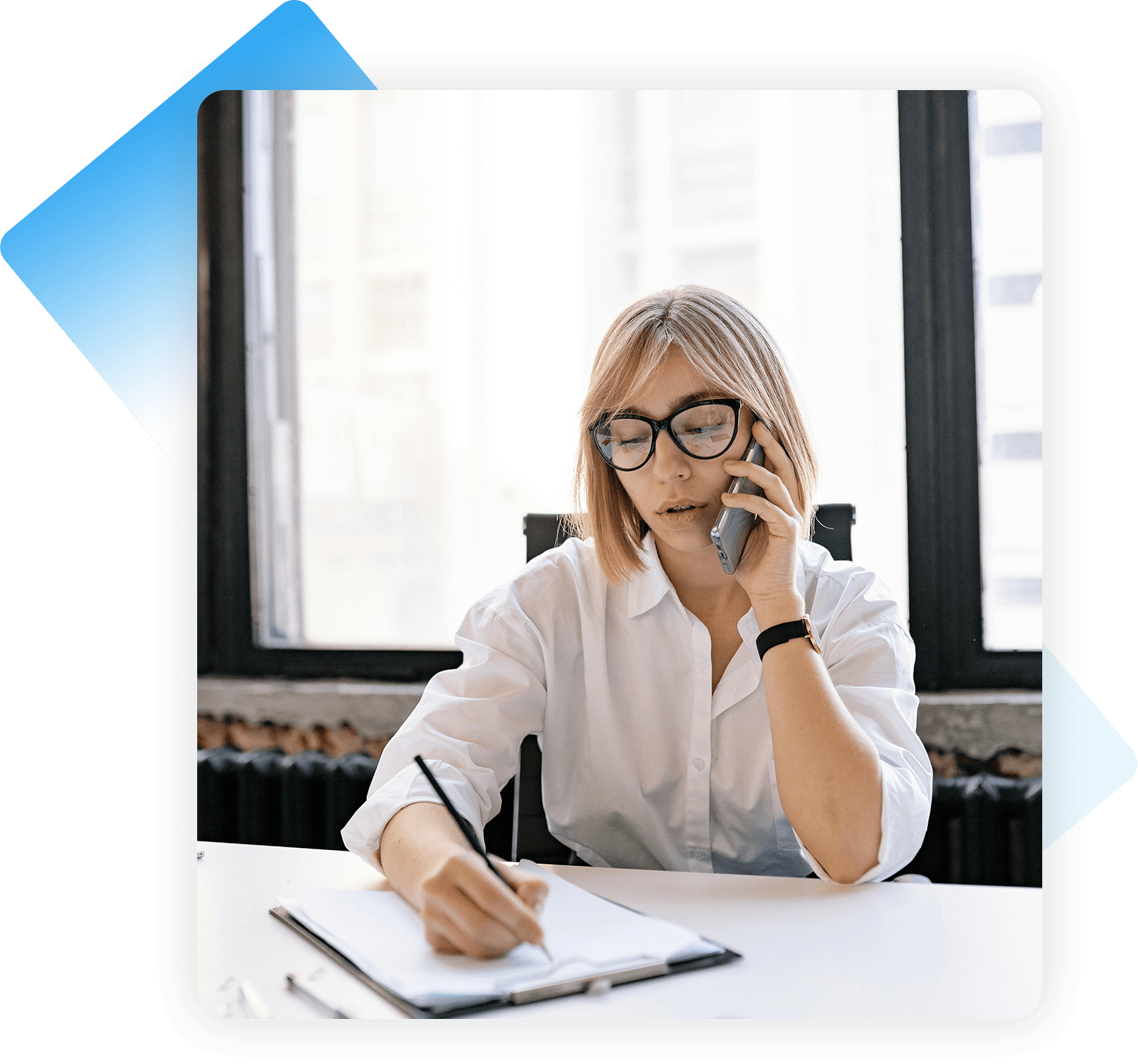 A woman sitting at a table talking on the phone.